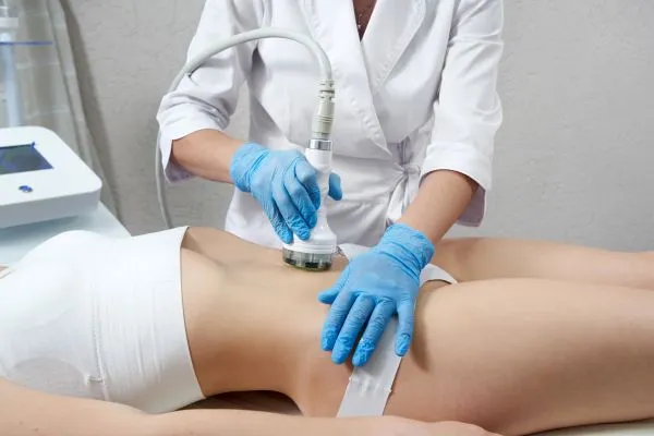 Lost the Weight but Not the Loose Skin? 2 woman having HIFU treatment on her stomach to combat loose skin Great Missenden following weight loss